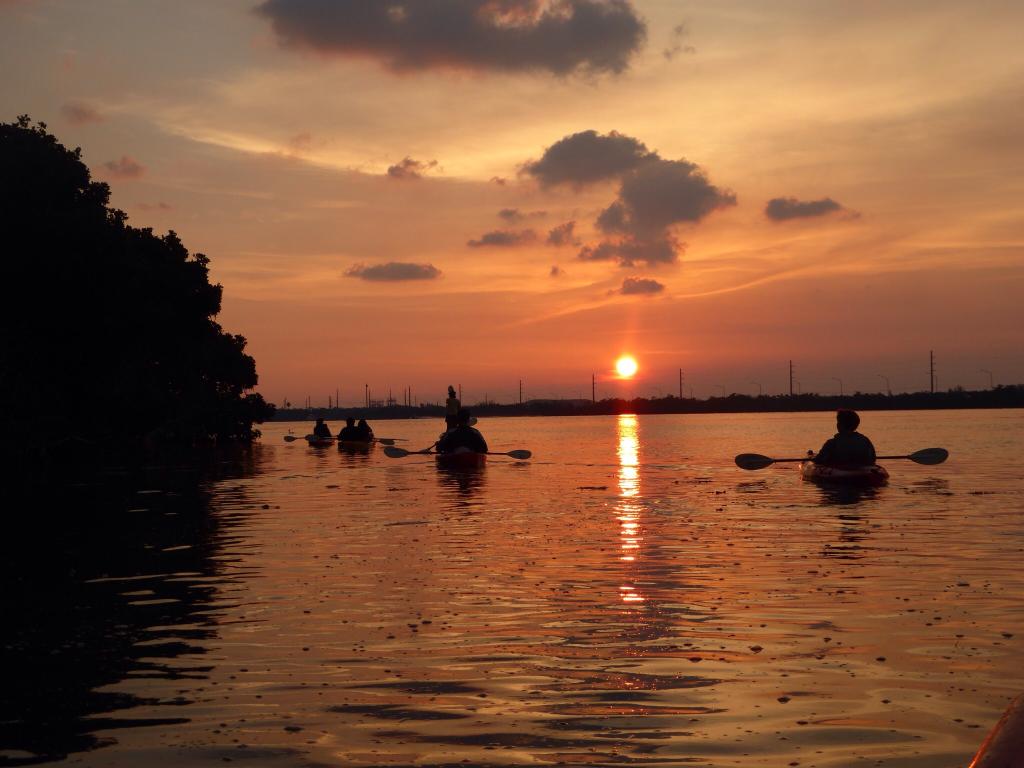 Kayaking on a lake with a beautiful sunset in the background